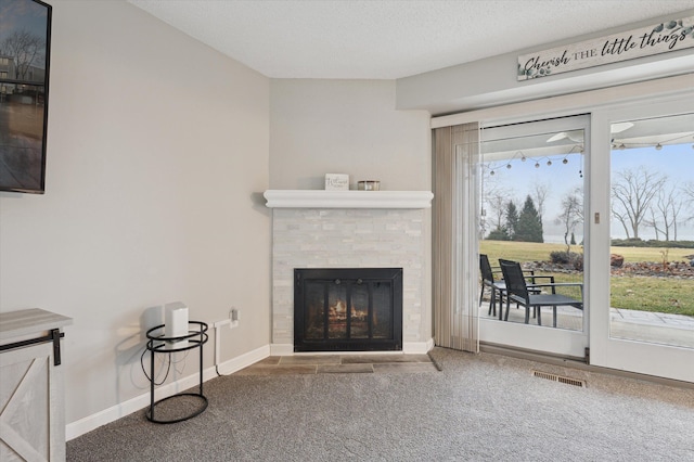 carpeted living room featuring a textured ceiling