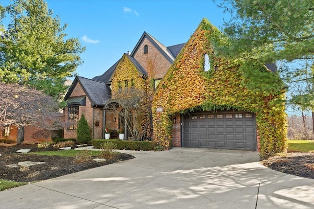 tudor-style house featuring a garage