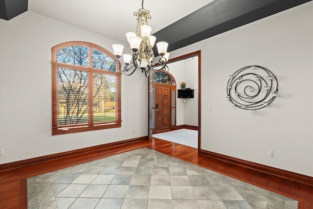 unfurnished dining area featuring light hardwood / wood-style flooring and an inviting chandelier