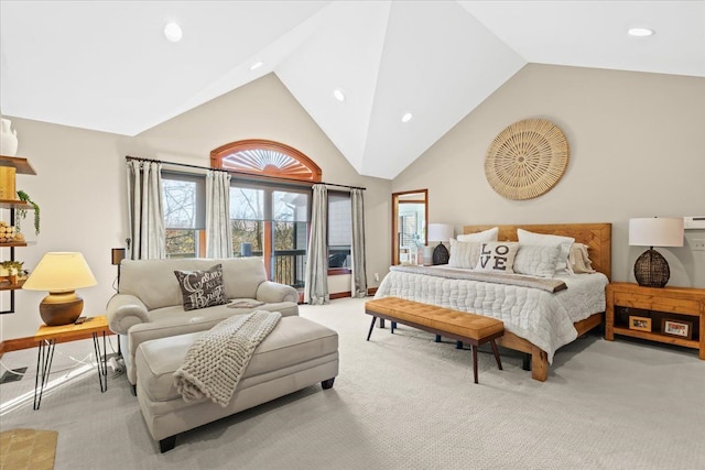 bedroom with high vaulted ceiling and light colored carpet