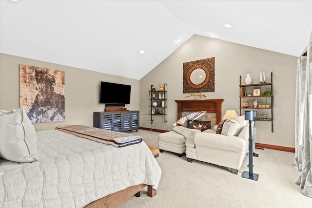 bedroom with lofted ceiling, light carpet, and a fireplace