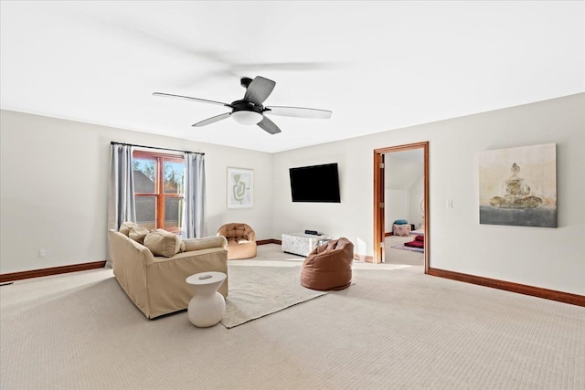 carpeted living room with ceiling fan