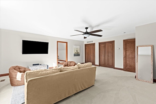 living room with ceiling fan and light carpet