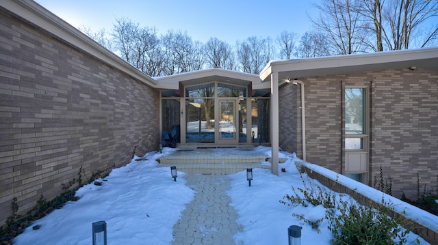 view of snow covered property entrance