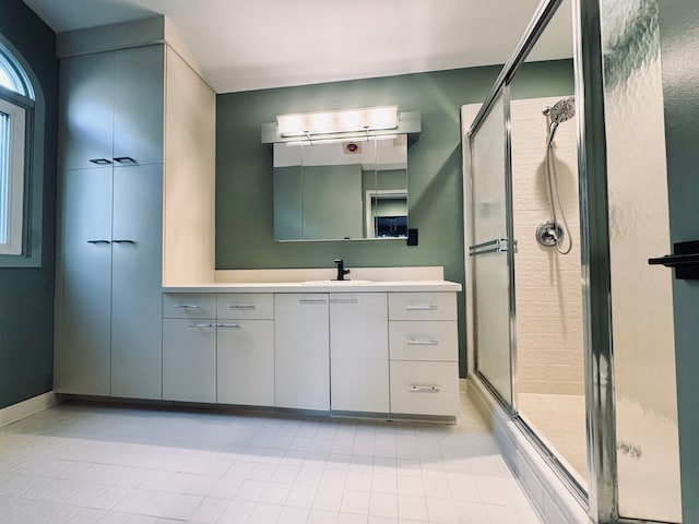 full bathroom featuring a stall shower, tile patterned floors, and vanity