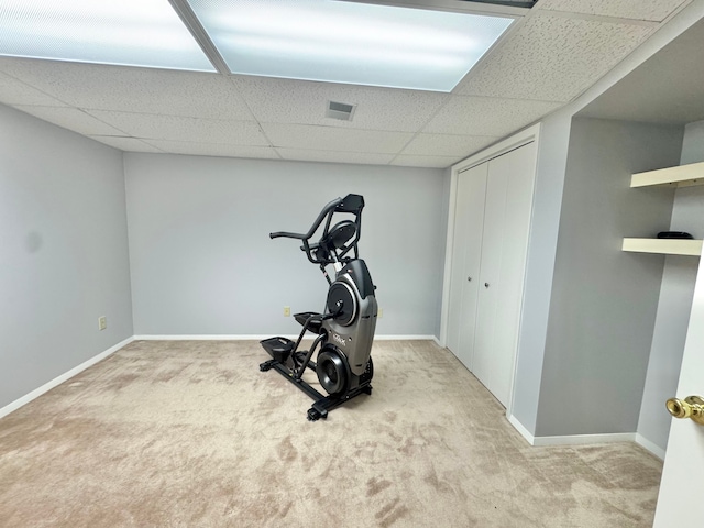 exercise room with carpet, visible vents, and baseboards