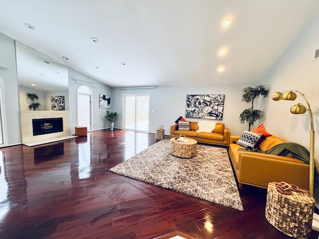 living room featuring lofted ceiling, a fireplace, wood finished floors, and recessed lighting