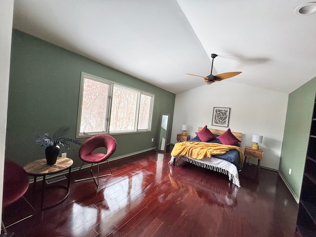 bedroom with lofted ceiling, baseboards, visible vents, and wood finished floors