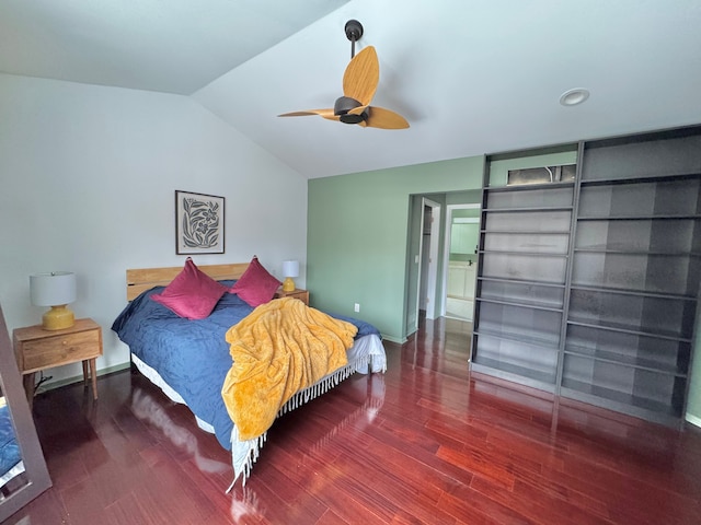 bedroom featuring a ceiling fan, dark wood finished floors, vaulted ceiling, and baseboards