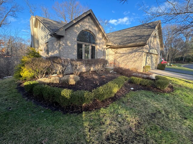 view of side of home with a yard