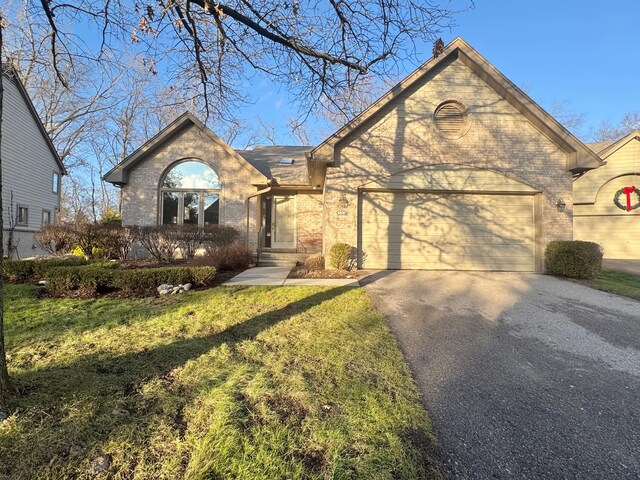 view of front of property with a front yard and a garage