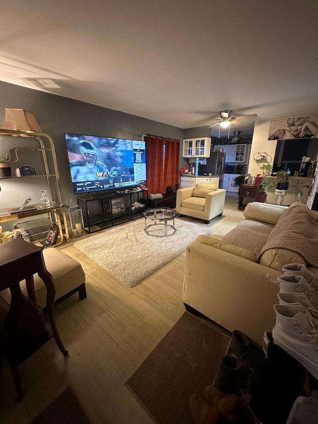 living room featuring ceiling fan and wood-type flooring