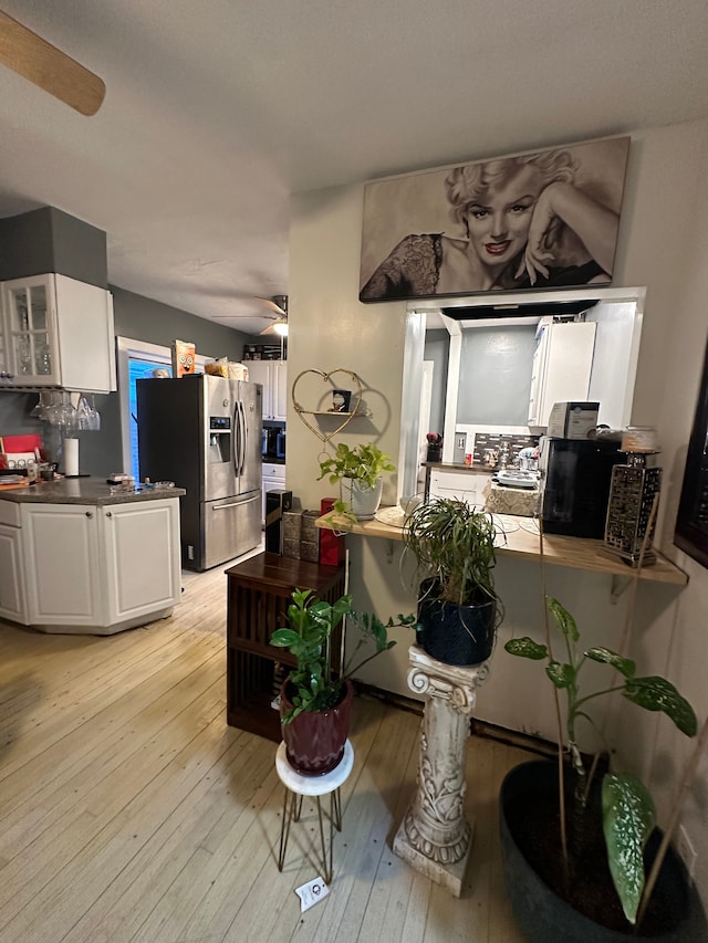 dining room with ceiling fan and light wood-type flooring