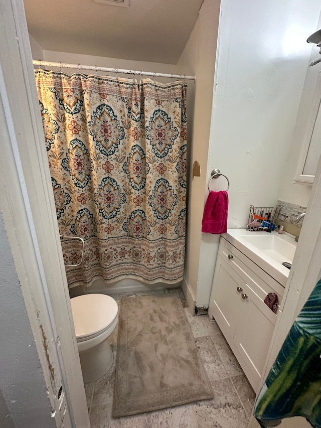 bathroom featuring vanity, a shower with curtain, and toilet