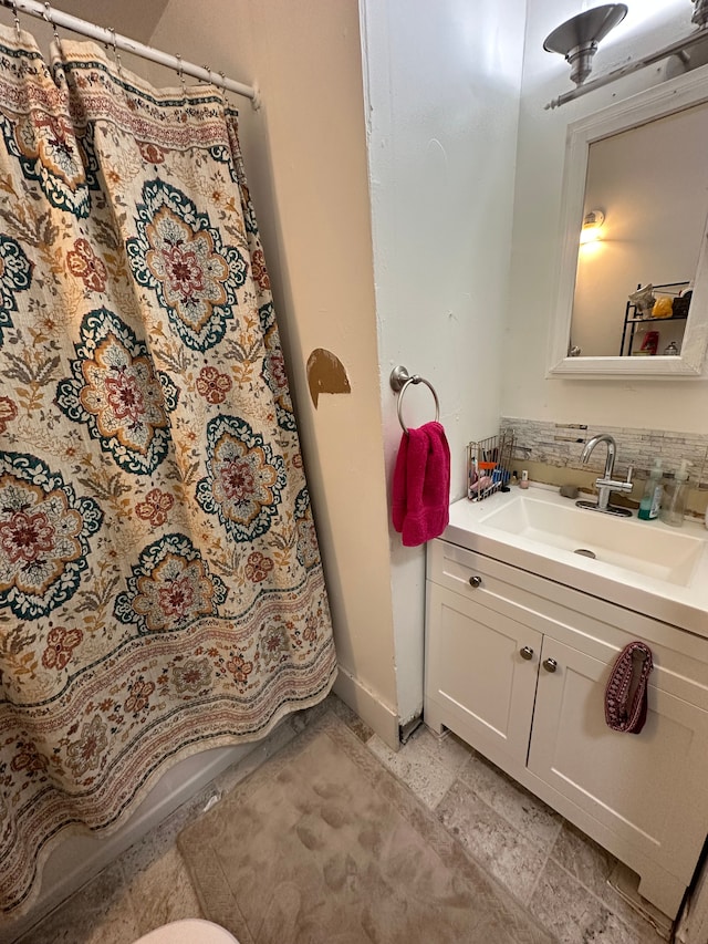 bathroom featuring tasteful backsplash and vanity