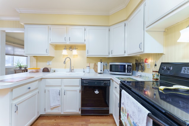 kitchen with sink, black appliances, kitchen peninsula, and white cabinets