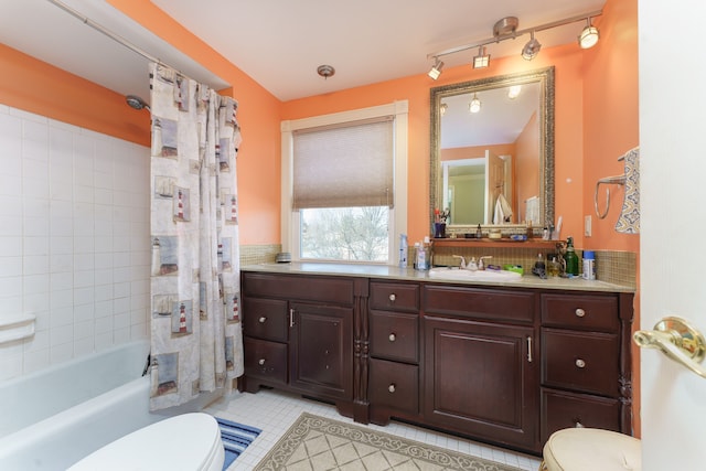 full bathroom featuring shower / bath combination with curtain, vanity, tile patterned floors, and toilet