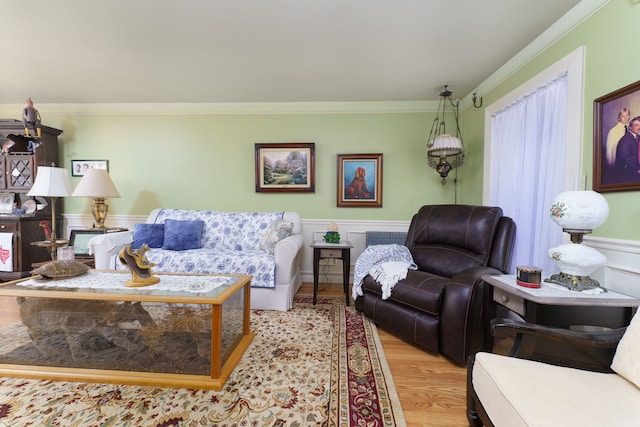 living room with light hardwood / wood-style flooring and ornamental molding