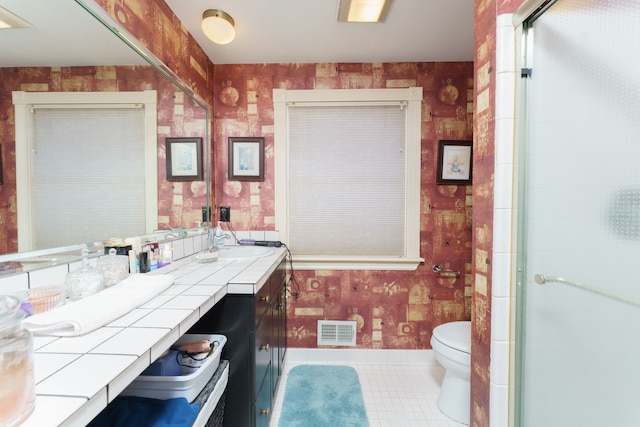 bathroom featuring tile patterned flooring, vanity, and toilet