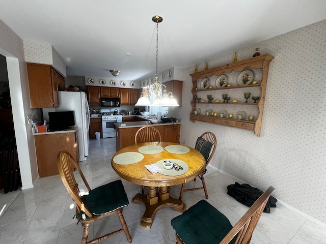 dining room featuring wallpapered walls, baseboards, marble finish floor, and a chandelier