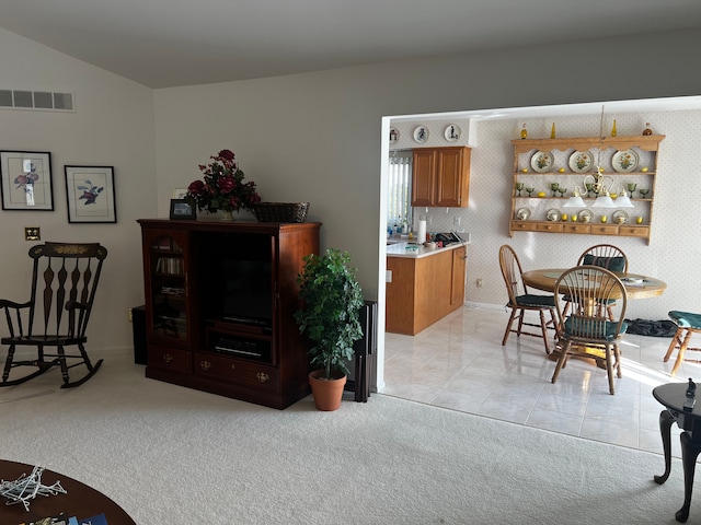 dining space with light carpet, light tile patterned floors, and visible vents