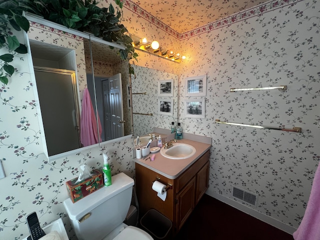 bathroom featuring wallpapered walls, a shower stall, and visible vents