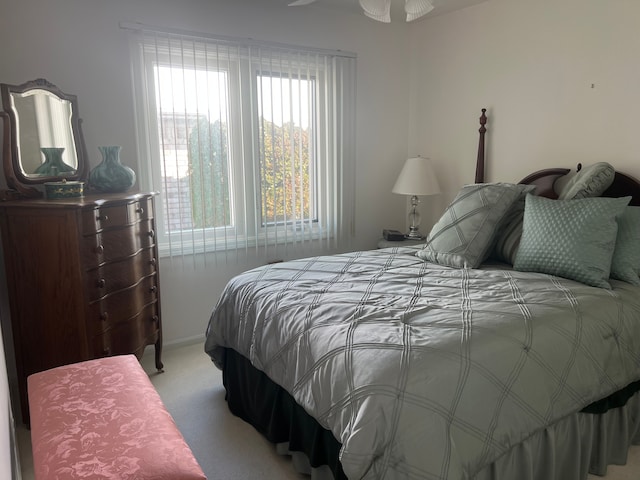 bedroom featuring light carpet and baseboards