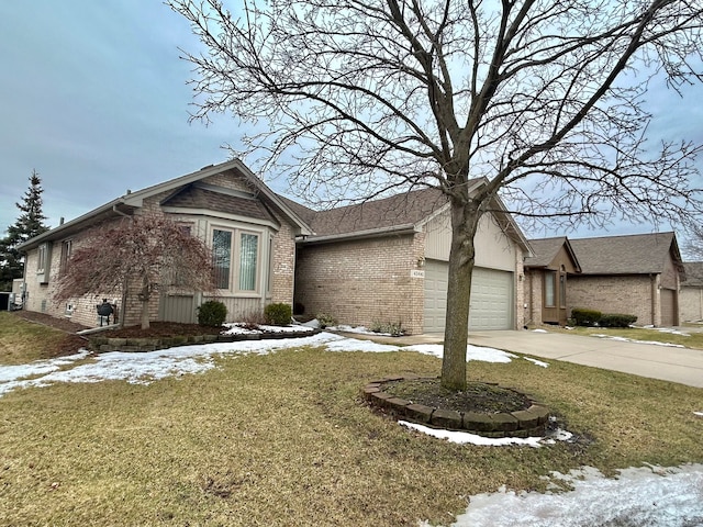 view of front of home featuring a garage, concrete driveway, brick siding, and a lawn