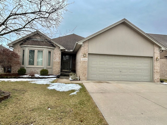 view of front of property with brick siding, a shingled roof, concrete driveway, an attached garage, and a front lawn