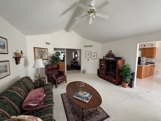 living area with vaulted ceiling with beams, a ceiling fan, visible vents, and light colored carpet