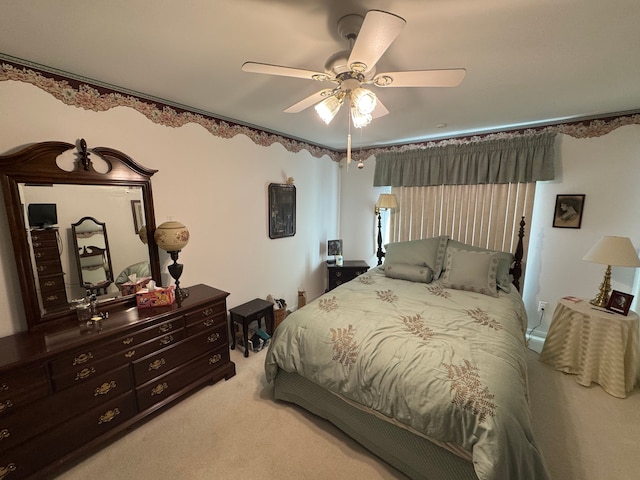 bedroom featuring a ceiling fan and light colored carpet