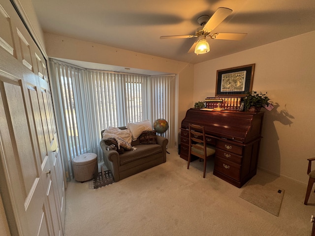 carpeted office space featuring ceiling fan