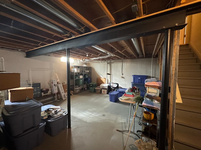 unfinished basement featuring stairs