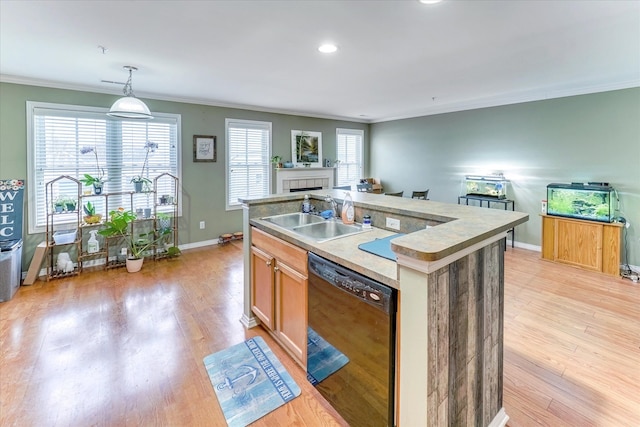 kitchen featuring an island with sink, dishwasher, ornamental molding, and sink