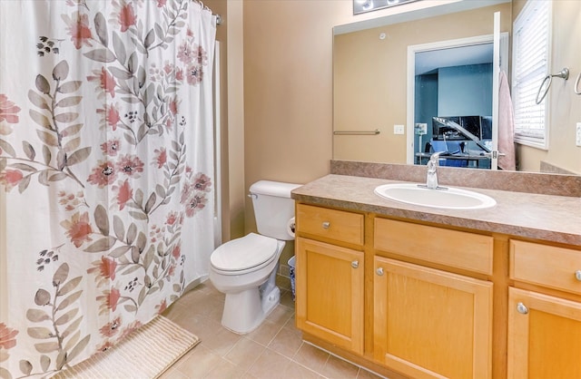 bathroom featuring toilet, vanity, tile patterned floors, and walk in shower