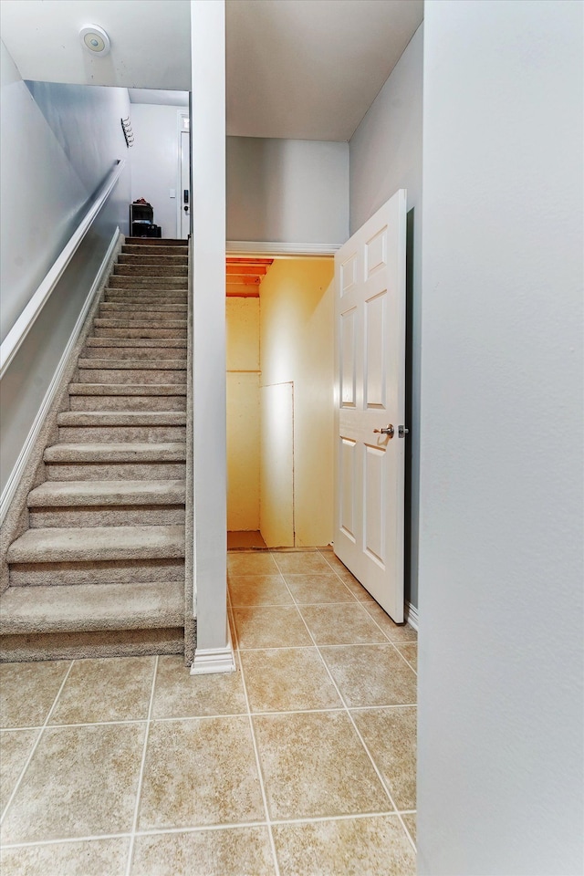 stairway featuring tile patterned floors