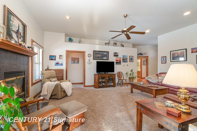 carpeted living room with a fireplace and ceiling fan