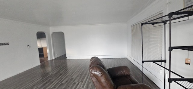 unfurnished living room with ornamental molding and dark hardwood / wood-style flooring