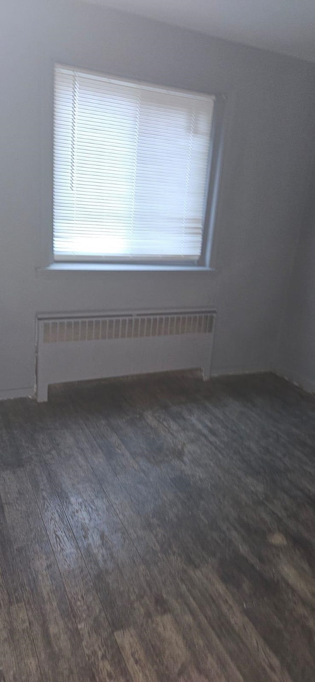 spare room featuring radiator heating unit