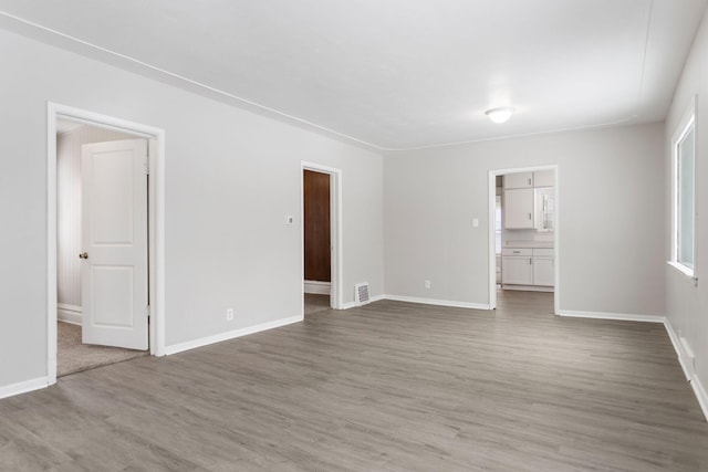 unfurnished room featuring dark wood-type flooring