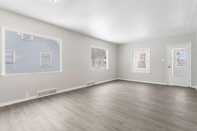 unfurnished living room with dark hardwood / wood-style flooring