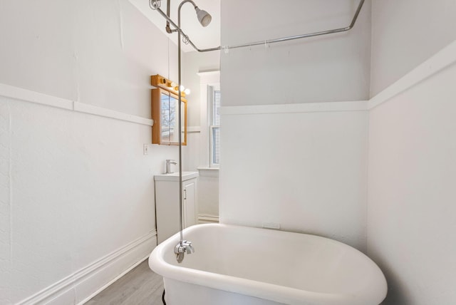 bathroom featuring a tub to relax in, vanity, and hardwood / wood-style flooring