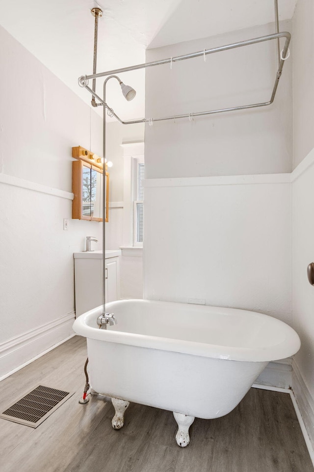 bathroom with a bath and wood-type flooring