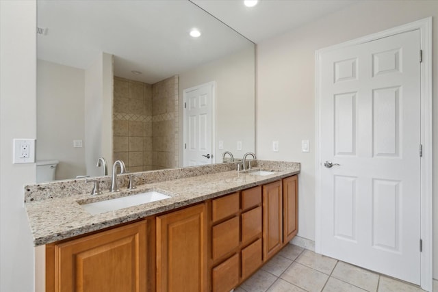 bathroom with toilet, tile patterned flooring, and vanity