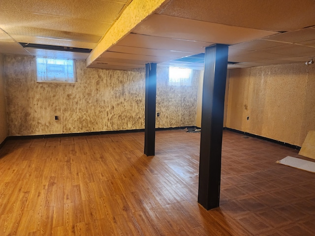 basement with a wealth of natural light and hardwood / wood-style flooring