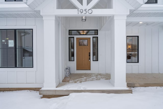 view of snow covered property entrance