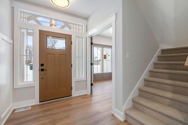 foyer entrance with light hardwood / wood-style floors