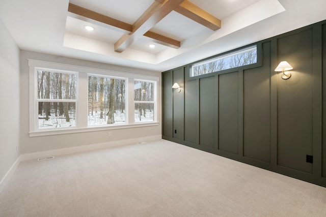 unfurnished bedroom featuring coffered ceiling, beamed ceiling, and light carpet