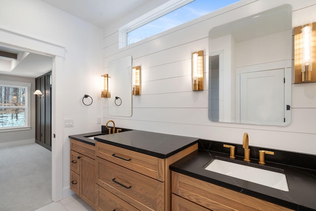 bathroom featuring tile patterned flooring, a healthy amount of sunlight, and vanity