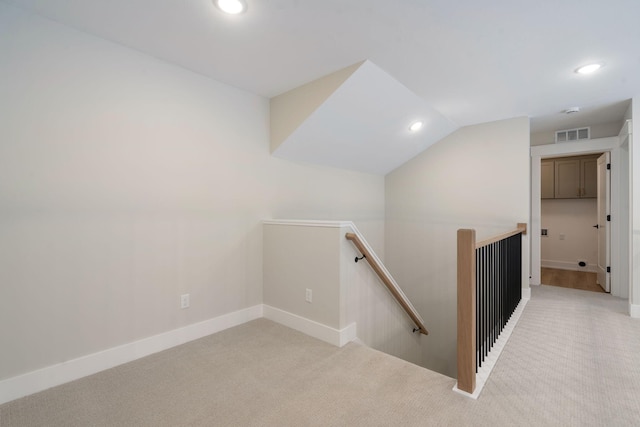 stairway with carpet and lofted ceiling